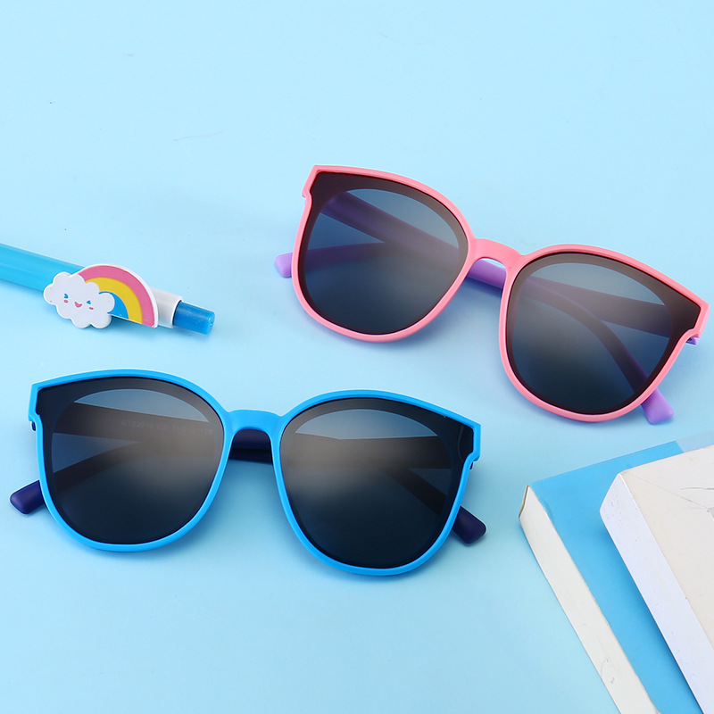 Kids sunglasses with tinted lenses on a soft blue background
